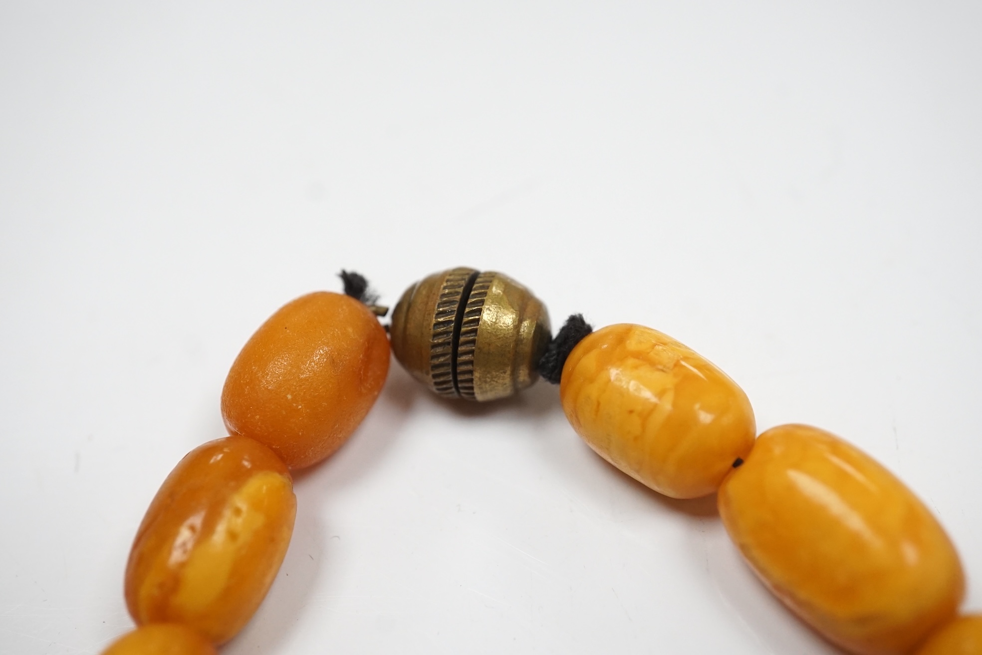 A single strand graduated oval amber bead necklace, 42cm, gross weight 49 grams. Condition - poor to fair